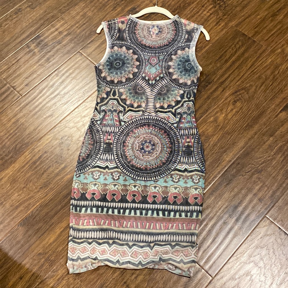 Pattern mesh see through dress, labeled size large, but fits like a small.